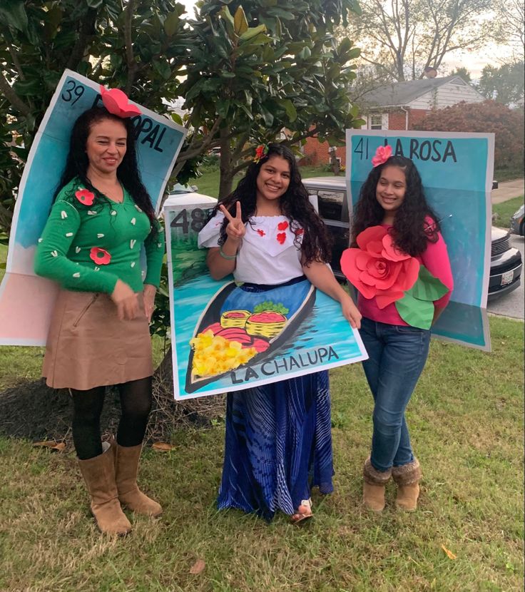 three women are standing in front of a sign