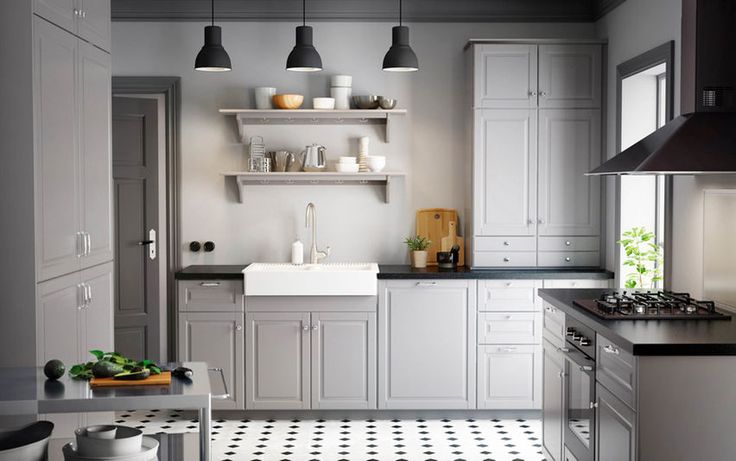 a kitchen with black and white tile flooring, shelves above the sink and cabinets