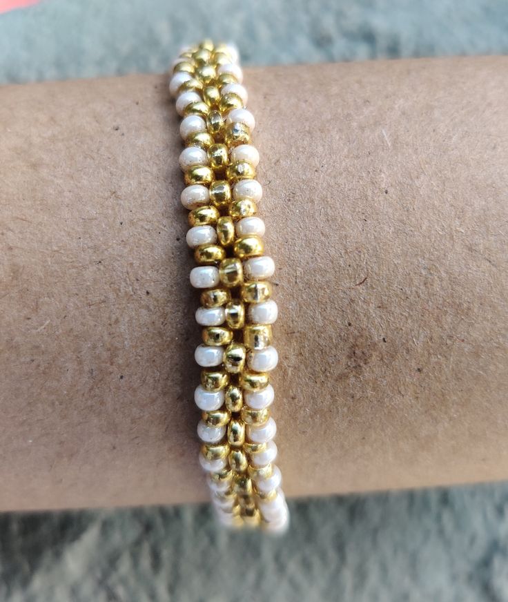 This delicate dainty faux pearl bracelets are carefully strung one by one to make it one unique. The golden stainless steel spacers give the elegant touch. Please choose your size in the variations menu. The beauty of this piece is that it is not only  elegant, but trendy and discret. Made with 2 mm czech crystal seed beads and carefully strung in stretch strand for durability and resistance. Dainty Pearl Stretch Bracelet With Round Beads, Dainty 14k Gold-filled Beaded Wedding Bracelets, White 14k Gold-filled Beaded Bracelets For Wedding, Dainty Adjustable Gold-plated Beaded Bracelets, Dainty Hand-strung White Pearl Bracelet, Bracelets Dainty, Mother Of Pearl Bracelet, Faux Pearl Bracelet, Pearl Bracelets