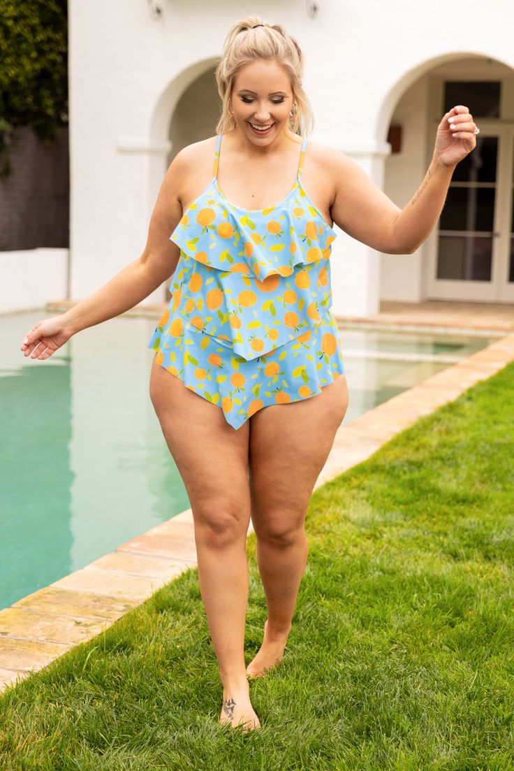 This swimsuit is calling your name! This chic swimmie has a fun orange print you can wear with your favorite cover-ups and sandals! It's comfortable for all day wear, has a figure-flattering one-piece design, and features the cutest ruffles along the body! Wear this swimsuit all season long! 82% Polyamide, 18% Elasthane Playful Spring Beach Tankini, Playful Tankini For Beach Party Season, Playful Summer Beach Tankini, Playful Summer Tankini For Beach Party, Playful Tankini For Spring Sunbathing, Playful Tankini For Summer Beach Party, Spring Poolside Printed Tankini, Playful Summer Tankini For Poolside, Playful Tankini For Beach Season Vacation