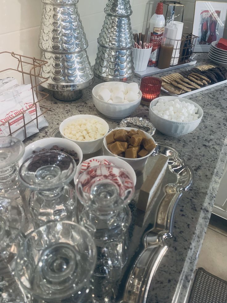 a kitchen counter topped with lots of different types of food and condiments on top of it