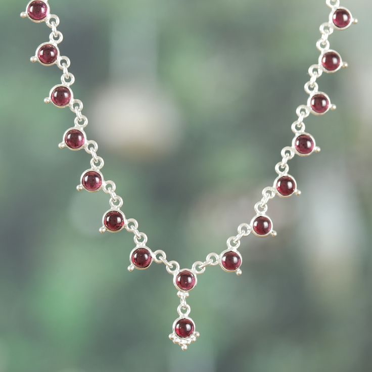 The splendor of the traditional Hindu dynasties survives the passage of time through jewelry artworks such as this superb design by Bhavya Jain of India. The artisan uses sterling silver to create this classic link necklace, whose high polish finish enhances each of the garnet jewels set around the accessory as a symbol of romantic beauty. Spiritual Garnet Gemstone Necklace, Spiritual Gemstone Necklaces For Celebration, Sterling Silver Temple Jewelry With Gemstone, Fine Jewelry Wedding Necklace With Cabochon, Wedding Fine Jewelry Necklace With Cabochon, Traditional Round Jewelry With Sterling Silver Clasp, Sterling Silver Cabochon Round Necklace, Sterling Silver Cabochon Necklace, Sterling Silver Round Cabochon Necklace