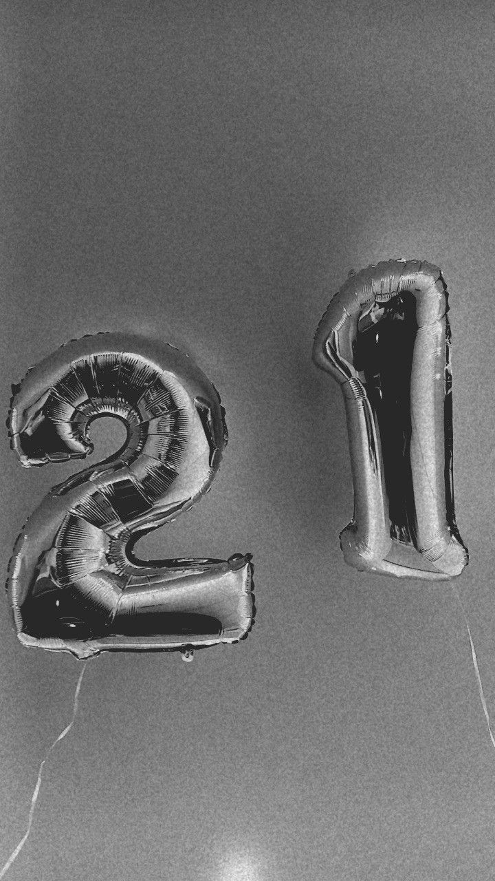 the number twenty two balloons are in the shape of numbers 2 and 3 on a table