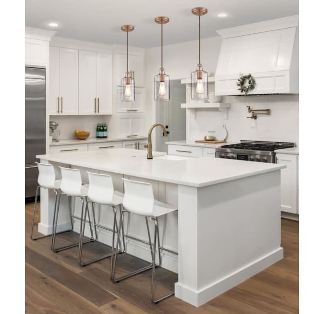 a large kitchen with white cabinets and stainless steel appliances