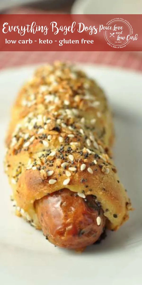 a close up of a hot dog on a plate with sesame seed sprinkles