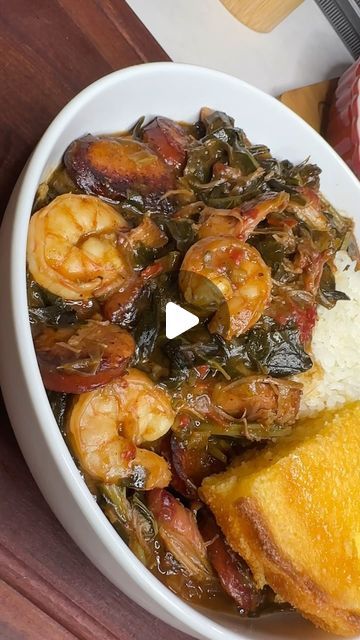 a white bowl filled with rice and shrimp next to other food on a wooden table