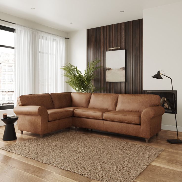 a living room with a brown couch and rug