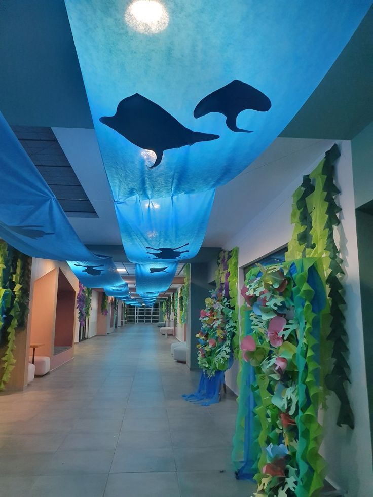 the hallway is decorated with blue and green seaweed, dolphins and other marine creatures