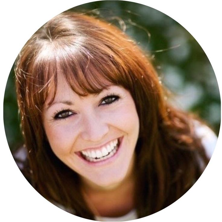 a smiling woman with red hair and blue eyes is in a circular photo, looking at the camera