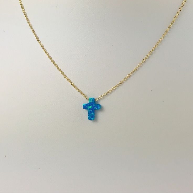 Description Simple. Chic. Minimalist™ A perfectly dainty brilliant synthetic fiery blue opal cross is floating freely on a delicate feminine 14k gold plated over Sterling silver chain. This cute and tiny star charm necklace features a synthetic created blue opal moon stone with sterling silver chain. This lovely star necklace is perfect for complementing a casual outfit, and you can even layerbit with other necklace to create something unique. * High Quality 925 Sterling Silver link chain with s Blue Cross Necklace, Opal Clavicle Chain Jewelry Gift, Nickel-free Blue Opal Jewelry, Blue Opal Nickel-free Jewelry, Opal Jewelry With Delicate Chain As Gift, Delicate Opal Chain Jewelry Gift, Delicate Opal Chain Jewelry As Gift, Delicate Opal Chain Jewelry For Gifts, Opal Jewelry With Adjustable Chain For Gift