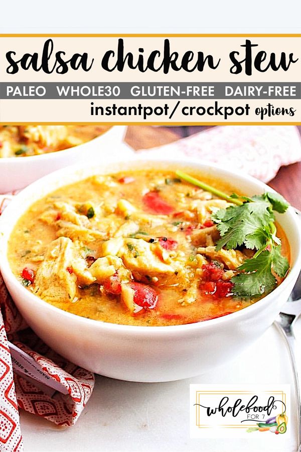 a white bowl filled with chicken stew on top of a table