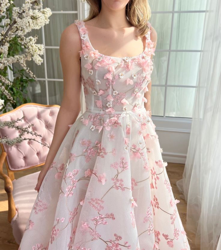 Experience the allure of springtime with our cherry blossom-inspired midi dress. This exquisite piece is crafted from delicate mesh fabric featuring 3D embroidered crystal flowers that capture the fleeting beauty of cherry blossoms. Designed with a flattering round neckline and a cinched waist accented by an elegant ivory bow belt, this dress combines sophistication with whimsy. Practical inseam pockets and a chic mini-skirt lining beneath the midi-length overlay add functionality and a touch of Spring Floral Embroidered Prom Dress, Spring Organza Knee-length Dress, Pink Spring Midi Dress For Prom, Spring Knee-length Organza Dress, Pink Midi Dress For Prom In Spring, Pink Midi Dress For Spring Prom, Spring Wedding Midi Dress With Floral Applique, Sleeveless Organza Midi Dress For Spring, Spring Prom Midi Dress With Floral Embroidery