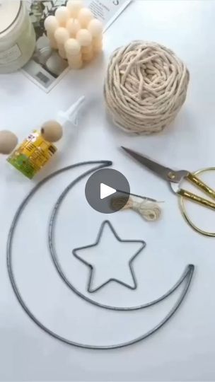 scissors, yarn, and other crafting supplies are on a table with balls of string