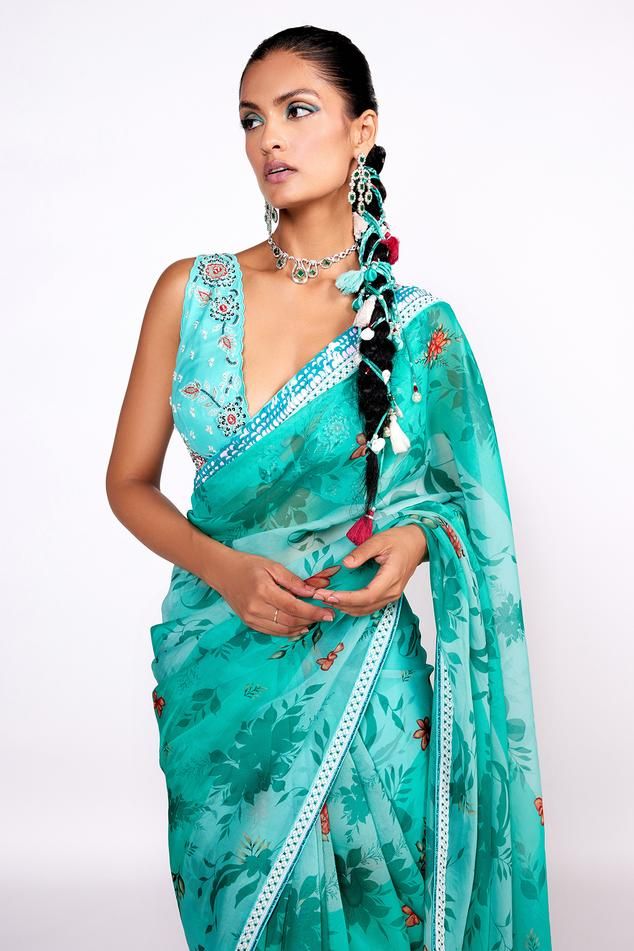 Aqua green organza saree with floral print and cutdana and sequins embroidered borders. Comes with a georgette blouse and a petticoat.
Components: 3
Pattern: Printed, Embroidered
Type Of Work: Floral, Cutdana, Sequins
Neckline: Deep V Neck
Sleeve Type: Sleeveless
Fabric: Saree : Organza, Blouse : Georgette, Petticoat : Satin
Color: Green
Other Details: 
Model Height : 5 ft 8 inches, wearing size S
Closure : Blouse - Back hook
Note : Head accessory worn by the model is not for sale.
Occasion: San Green Floral Pre-draped Saree For Festivals, Green Georgette Pre-draped Saree For Transitional Season, Transitional Green Saree With Sheer Dupatta, Festive Green Saree, Festive Green Sleeveless Saree, Anarkali Saree With Floral Print For Party, Green Traditional Pre-draped Saree For Summer, Green Saree For Summer Party, Party Saree With Floral Print For Festivals