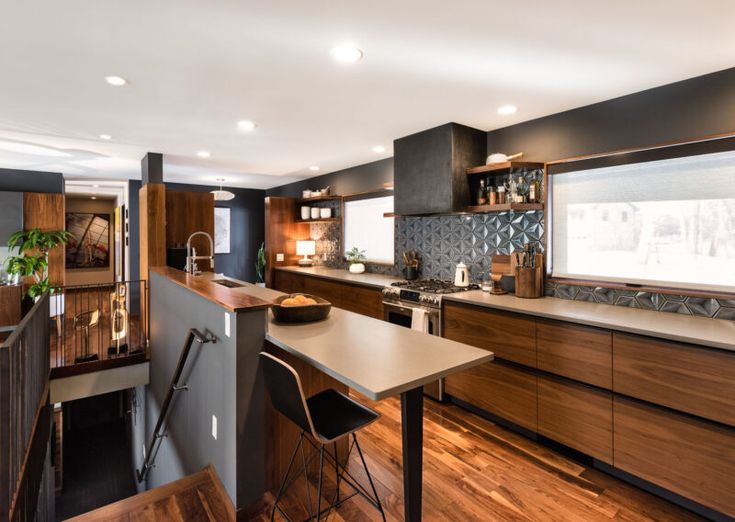 a modern kitchen with wooden cabinets and counter tops