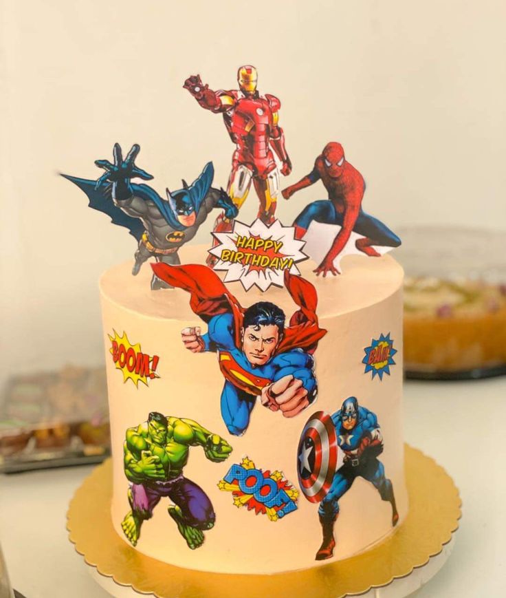 a birthday cake decorated with comic characters on it