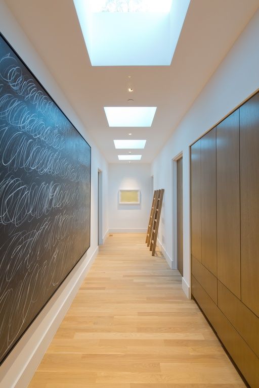 an empty hallway with large chalkboard on the wall