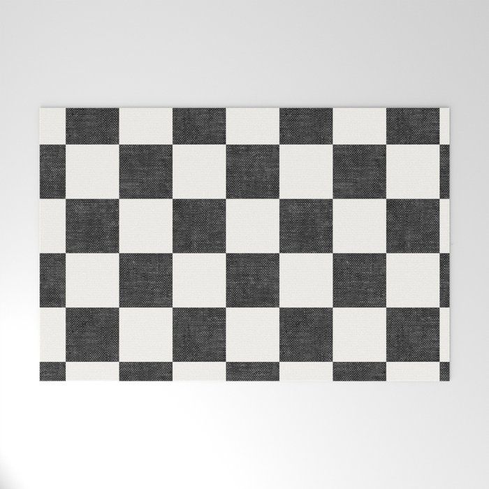 a black and white checkerboard pattern is on the wall