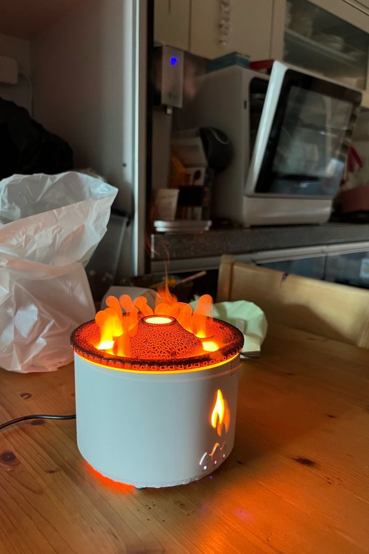 a lit candle sitting on top of a wooden table