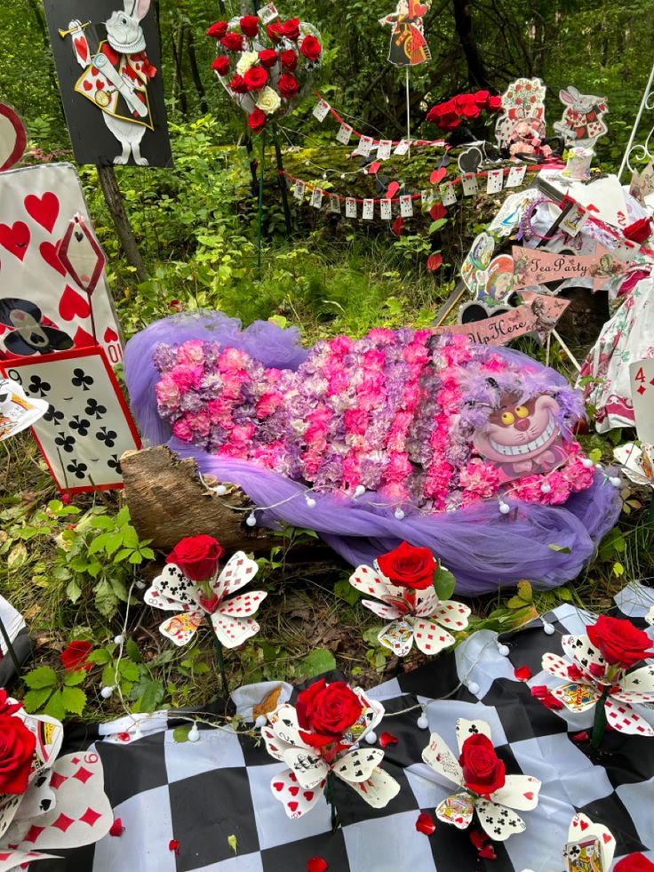 a table topped with lots of cards and flowers on top of a checkered cloth