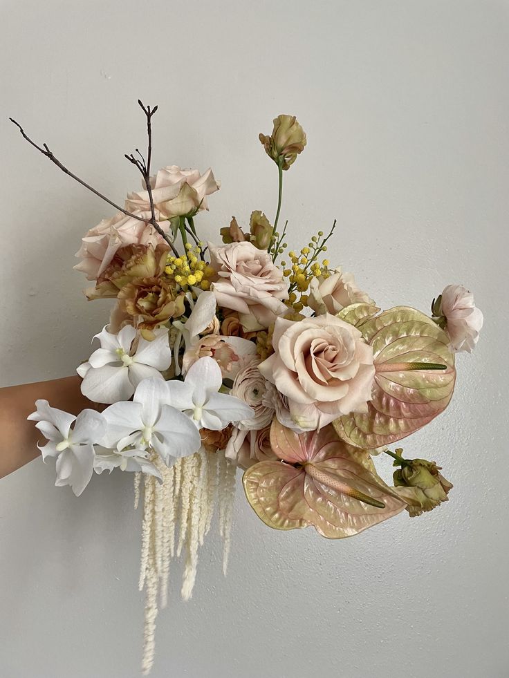 a person holding a bouquet of flowers in their hand