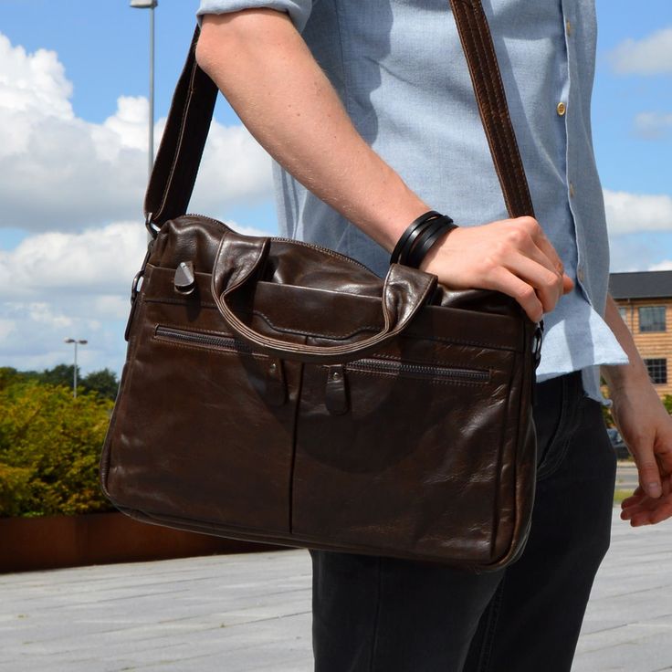 Fashioned from high-quality chestnut brown cow leather, this masculine beauty comes with plenty of space for your laptop, documents, books, and more. Inside, you'll find 1 large central compartment and a padded pocket for safely carrying your laptop, as well as smaller pockets for phones, keys, and your wallet. On the back, there's a neat quick access pocket, as well as 3 pockets in front, two with zippers. No more running out of space. Reinforced stitching on the adjustable shoulder strap and the top handles means you can carry all your personal items safely. Brown Leather Laptop Bag, Leather Computer Bag, Out Of Space, Brown Cow, Computer Bag, Leather Laptop Bag, Chestnut Brown, Leather Laptop, Computer Bags