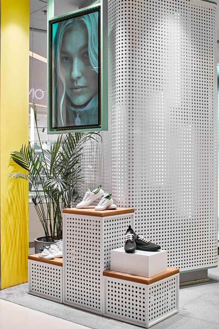 the inside of a shoe store with shoes on display