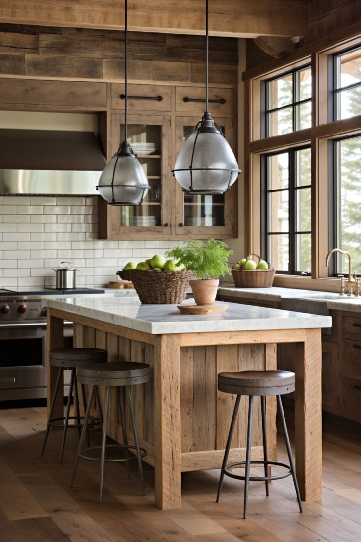 a kitchen with wooden floors and two hanging lights above the island, surrounded by stools