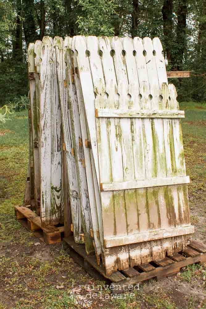 an old wooden outhouse sitting in the grass