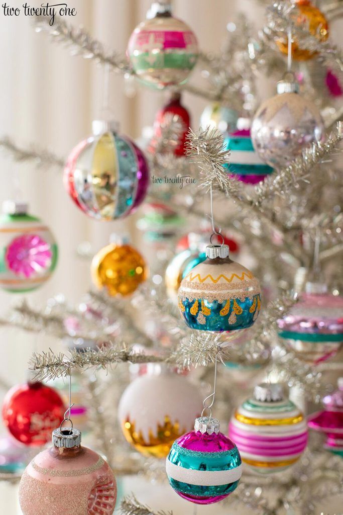 a white christmas tree with ornaments hanging from it