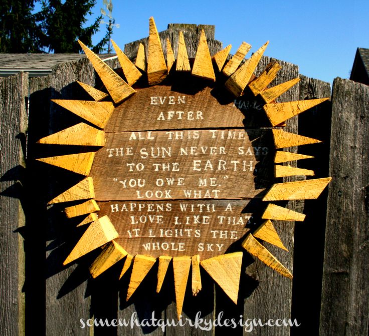 a wooden plaque on the side of a fence that says, even after all there is sun never say to the earth you love me look what happens with love