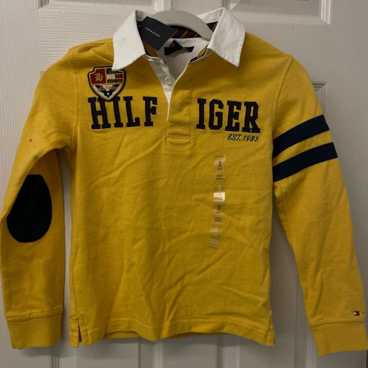 Size Small 6/7 New With Tags Yellow Crew Neck Shirt For Fall, Fall Yellow Crew Neck Shirt, Sporty Mustard Cotton Tops, Yellow Long Sleeve T-shirt For Spring, Sporty Yellow Long Sleeve T-shirt, Yellow Fitted School Top, Yellow Fitted Tops For School, Yellow Cotton Tommy Hilfiger Top, Sporty Long Sleeve Tommy Hilfiger Top