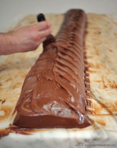 someone is decorating a chocolate covered pastry