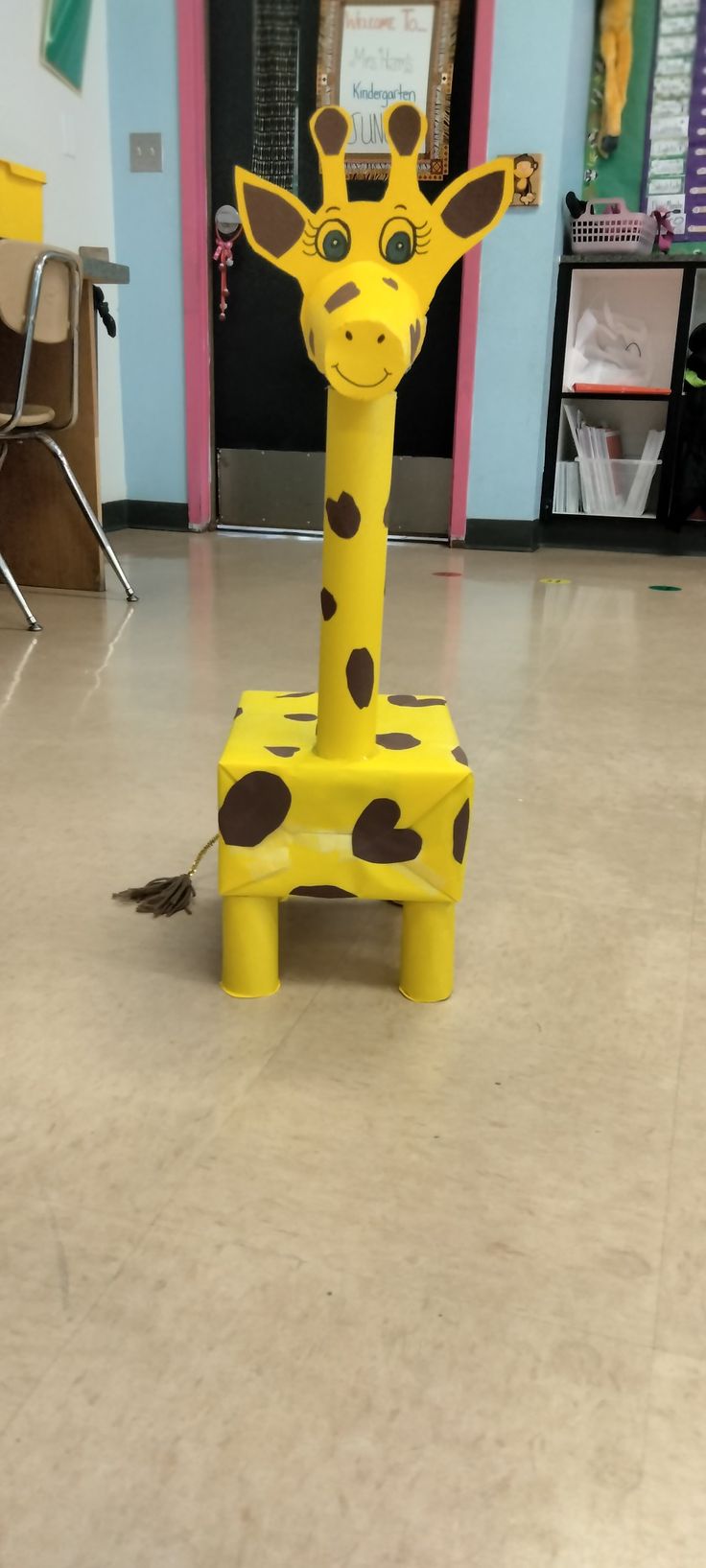 a toy giraffe sitting on top of a floor