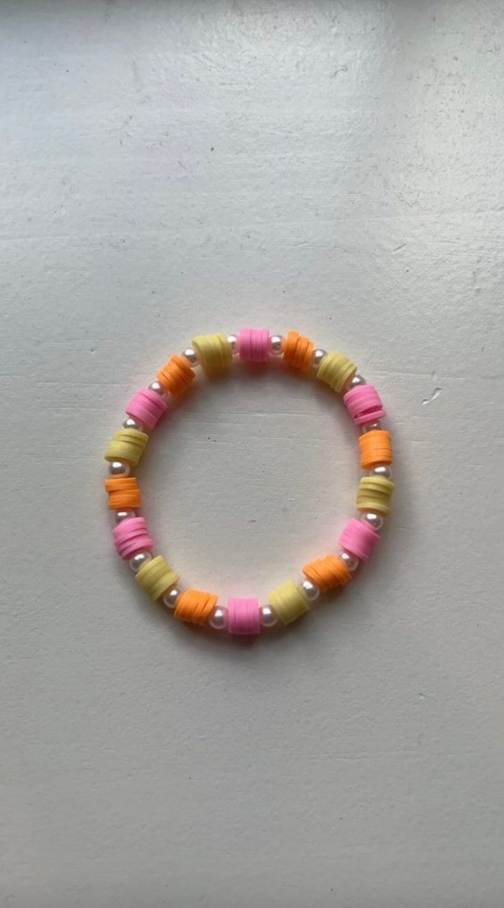 The Summer Sunset Bracelet is a radiant, eye-catching piece of jewelry featuring a pattern of yellow, orange, and pink clay beads. Each colorful section is beautifully separated by a lustrous pearl charm. Evoking the beauty of a summer sunset, this bracelet brings a delightful splash of warmth and elegance to any outfit! Every bracelet comes in 4 different sizes to choose from, ensuring that it fits perfectly on your wrist. Color Naranja Aesthetic, Bracelet Inspo Aesthetic, Naranja Aesthetic, Sunset Bracelet, Clay Bead Bracelet, Clay Bracelet, Bracelets Diy, Clay Bead, Pink Clay