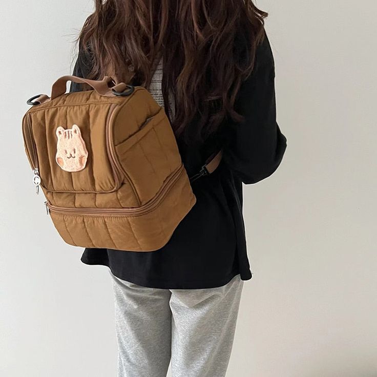 a woman with long hair wearing a brown backpack