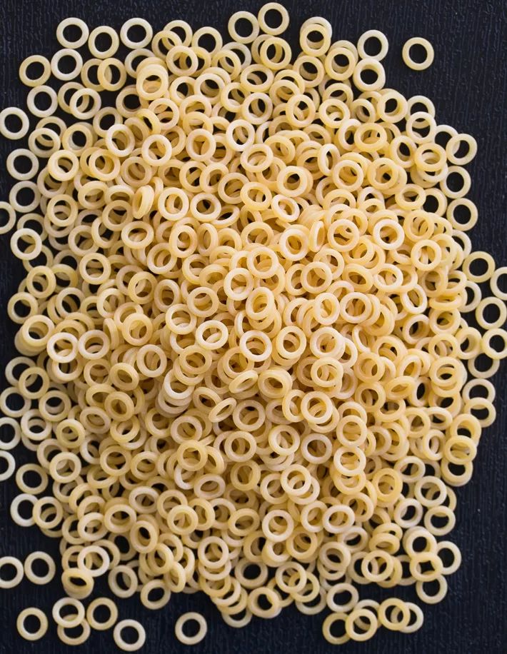 a bunch of rings are in the shape of a circle on a black tablecloth