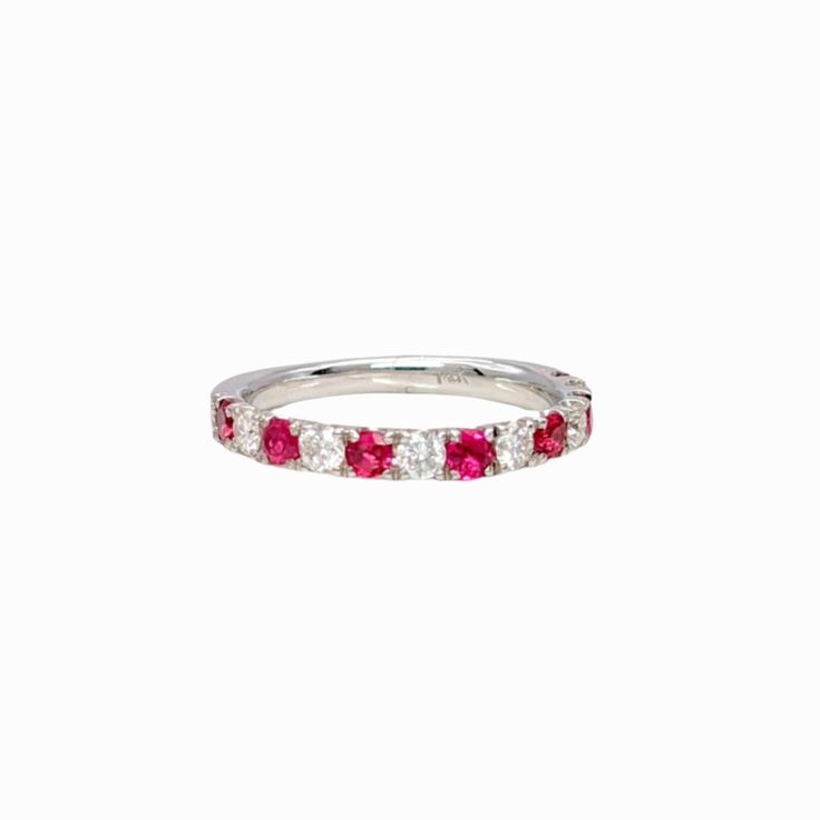 a white gold band with pink and white diamonds on it, in front of a white background