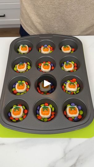 a muffin tin with cupcakes in it on top of a white counter