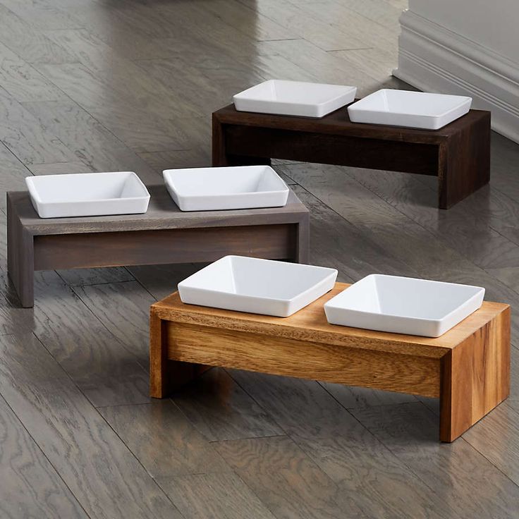 four white bowls on wooden tables in a room