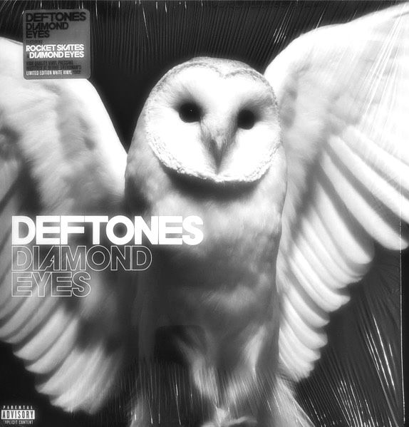 an owl with its wings spread out and the words deftones diamond eyes on it