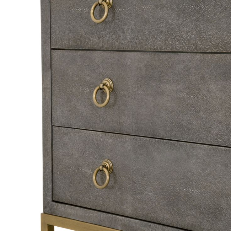 a grey dresser with gold handles and two drawers on each side, one drawer has an oval handle