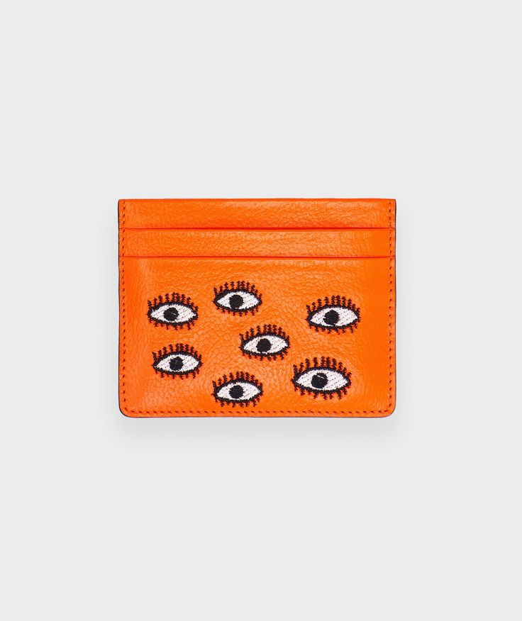 Color: Neon OrangeEmbroidery: All Over Eyes Dimensions: 4”W x 3”H Materials: Genuine leather; monogram printed cotton lining Features: 100% crafted by hand in small batches in Colombia Six card pockets Orange Rectangular Card Holder With Card Slots, Orange Rectangular Card Holder With Slots, Wallet Inspiration, Eyes Embroidery, Designer Handbag Brands, Dope Jewelry Accessories, Leather Monogram, Luxury Lifestyle Fashion, Leather Cardholder