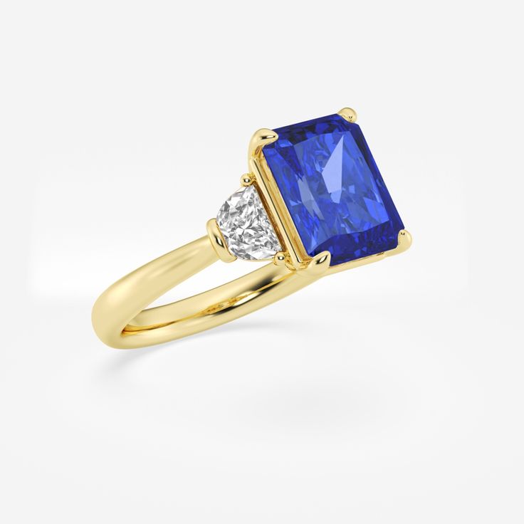 Step into the spotlight with this gorgeous sapphire three stone ring, crafted with a breathtaking radiant cut. This showstopper will draw admirers in with its mesmerizing blue color, while the unique faceting creates a dazzling display of scintillation. Complemented by diamond side stones, this ring strikes the perfect balance between bold and timeless. Gia Certified Radiant Cut Sapphire Diamond Ring, Radiant Cut Sapphire Ring With Cubic Zirconia, Luxury Square Cut Brilliant Sapphire Ring, Luxury Square-cut Brilliant Sapphire Ring, Luxury Square-cut Sapphire Ring With Brilliant Cut, Square-cut Brilliant Sapphire Ring, Square Cut Brilliant Sapphire Ring, Radiant Cut Sapphire Ring With Accent Stones, Luxury Sapphire Ring With Accent Stones, Square Cut