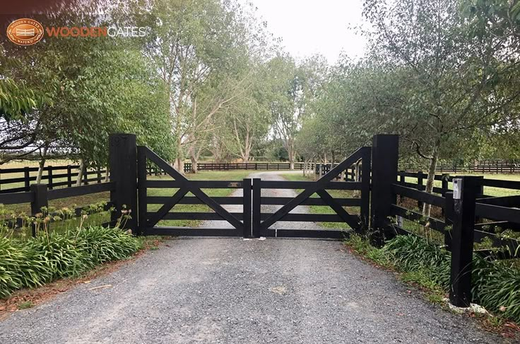 an open gate leading to a dirt road