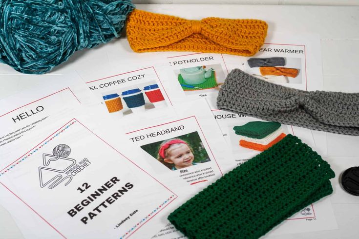 crocheted headbands and knitting supplies laid out on top of a table