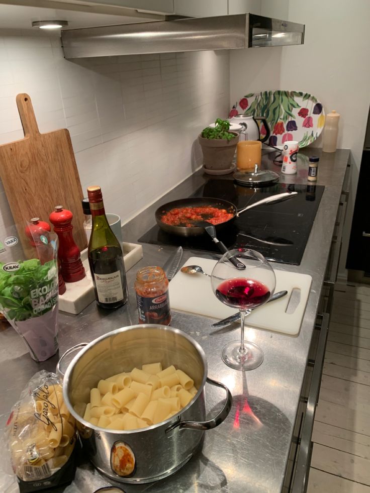 a kitchen counter topped with lots of food and wine