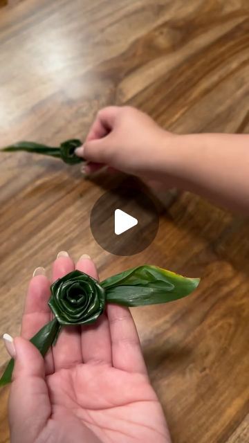 someone is holding a fake flower in their hand while another person holds it up to the camera