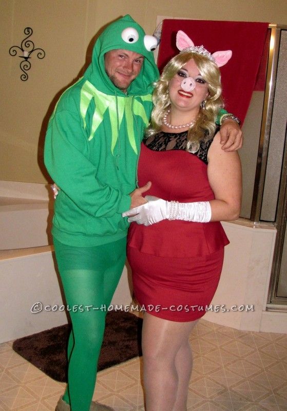 two people dressed in costumes standing next to each other, one wearing a costume and the other as a frog