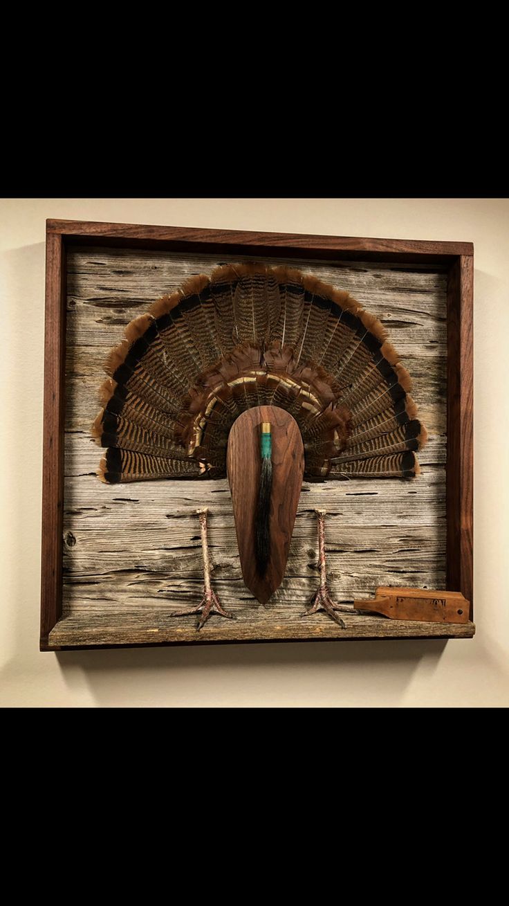 a wooden wall hanging with a bird on it